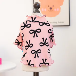 Pink pet shirt with black bow patterns and ruffled edges for small dogs and cats