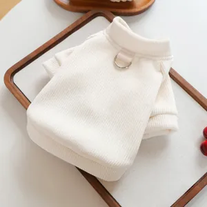 Detail of cream pet sweater featuring ribbed knit texture and a metal D-ring for leash