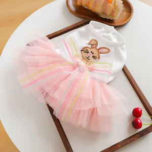 Detail of pet dress featuring cute rabbit embroidery and layered pink mesh skirt