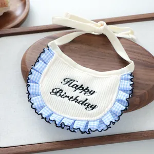 Detail of Happy Birthday pet bib with blue plaid ruffles and knit fabric for cats and dogs
