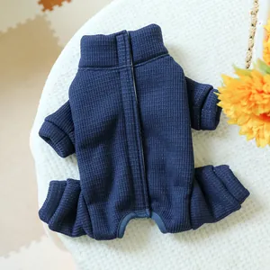 Close-up of deep blue waffle knit pet jumpsuit with ribbed cuffs on white plush background