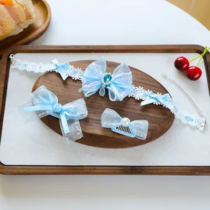 Detail of blue lolita style pet accessory set with lace choker and bow hair clips