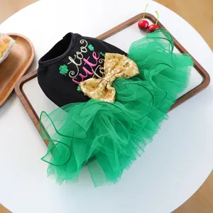 Detail of pet dress with golden sequin bow and too cute embroidery on green mesh