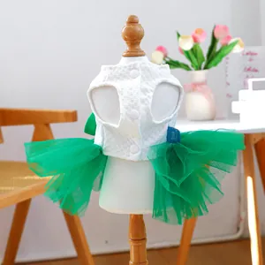 Detail of pet dress featuring green tulle skirt and white waffle texture top on wooden stand