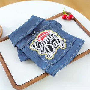 Detailed blue denim pet vest featuring Game Day embroidery and a metal D-ring for leash