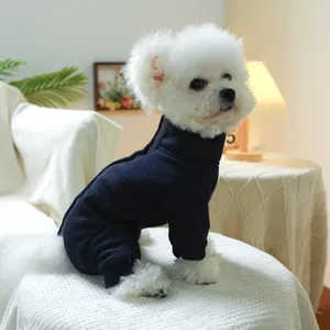 Navy blue knit pet jumpsuit with back zipper on a small white dog for winter