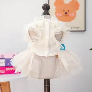 Detail of pet wedding dress featuring layered tulle skirt and floral lace texture