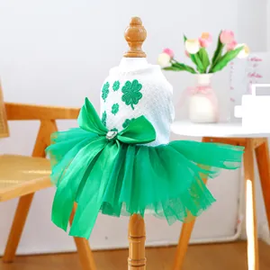 Detail of green tulle pet dress with clover embroidery and large satin bow for St. Patrick's Day