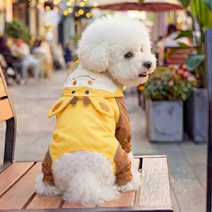 Detail of waterproof giraffe dog raincoat featuring 3D ears and ribbed cuffs on the street