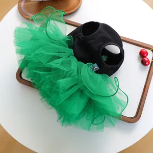 Detail view of pet dress with green layered tulle skirt and clover embroidery pattern