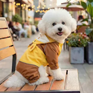 Detail of yellow pet raincoat featuring safety reflective strips and duck-shaped hood