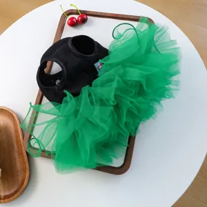 Detail of pet dress featuring a black knit vest and layered vibrant green mesh tutu skirt
