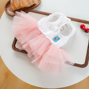 Detail of pet Easter tulle dress featuring pink mesh layers and cotton vest with buttons