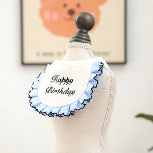 Detail of blue plaid ruffle dog bandana with Happy Birthday embroidery on soft cotton