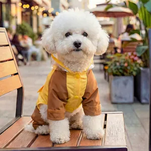 Detail of waterproof dog raincoat with transparent visor and snap button closure