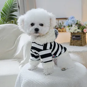 Detail of striped pet hoodie featuring plush faux fur trim and a decorative grey pom-pom