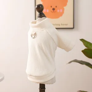 Close-up of cream dog sweatshirt with ribbed knit texture and metal D-ring for leash attachment