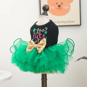 Detail of pet dress featuring green tulle skirt and large gold sequin bow on a mannequin