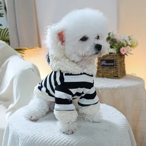 Close-up of pet sweater featuring green striped knit fabric and soft fleece trim