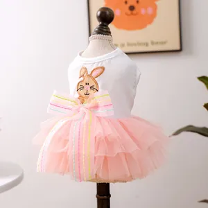 Detail of pet dress with rabbit embroidery and pink tulle skirt on a wooden model