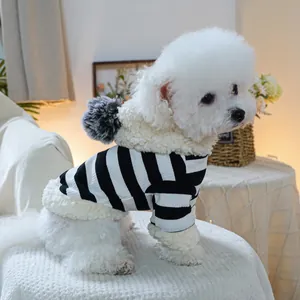 Detail of striped pet hoodie with plush white fleece hood and decorative pom-pom ball
