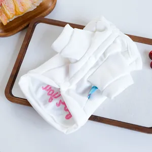 Gros plan d'un gilet blanc pour animal avec boutons-pression et broderie rose Baby
