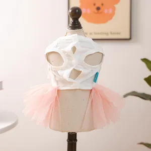 Detail view of pink multi-layer mesh pet tutu dress with white buttons and brand tag