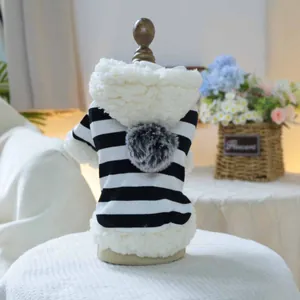 Close-up of striped pet hoodie with faux fur trim and a fluffy pom-pom on the hood