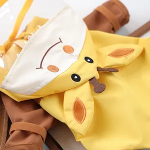Detail of yellow cartoon giraffe dog raincoat with hood embroidery and clear brim