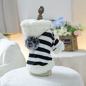 Detailed view of striped pet hoodie featuring fuzzy pompom and soft sherpa fleece lining