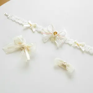 Detail of cream lace pet collar and hair clips with amber gems and pearls