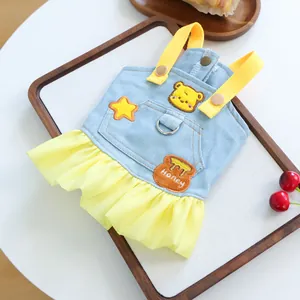 Detail of dog denim dress featuring honey bear embroidery and yellow tulle skirt