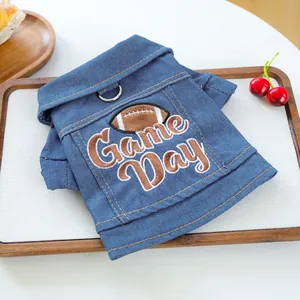 Detail of denim pet vest with Game Day embroidery and metal D-ring for leash