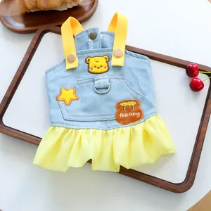 Detail of denim dog dress with honey bear embroidery and yellow pleated chiffon hem