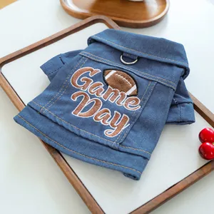 Close-up of denim pet jacket with Game Day embroidery and metal D-ring for leash attachment