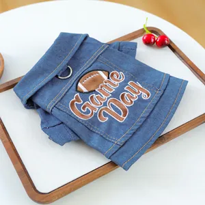 Detail of pet denim vest featuring Game Day embroidery and metal D-ring for leash attachment