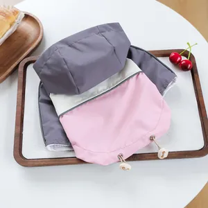 Detail of pet windbreaker featuring pink and grey splicing with breathable mesh lining