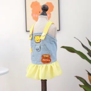 Detail of dog denim dress with honey bear embroidery and metal leash ring on the back