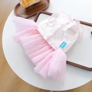 Close-up of pink layered mesh tutu and white floral lace embroidery on pet dress