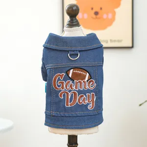 Detail of blue denim pet vest featuring Game Day embroidery and metal D-ring attachment