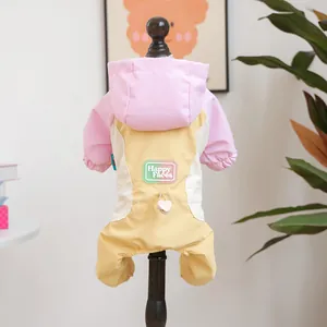 Detailed view of color-block pet jumpsuit with Happy Faces print and heart charm