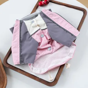 Detail of pink and grey pet vest with breathable mesh lining and button closure
