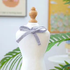Close-up of blue and white striped pet bow tie on a display mannequin neck