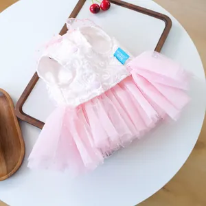 Detail of pink pet wedding dress with lace floral bodice and tiered fluffy tulle skirt