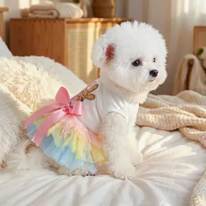 Rainbow tulle pet dress with bunny embroidery and pink satin bow on a white dog