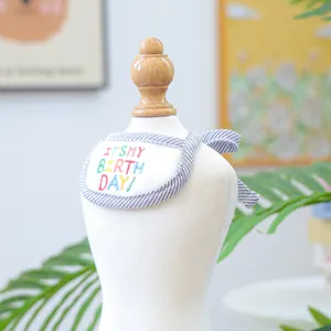 Detail of pet birthday bandana with It's My Birthday embroidery and blue striped trim
