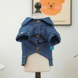 Detail of pet denim jacket with copper buttons and branded label on miniature model