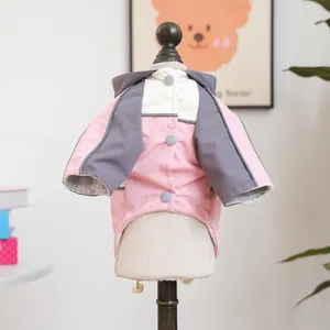 Close-up of pink and grey pet hoodie showing back buttons and windproof texture