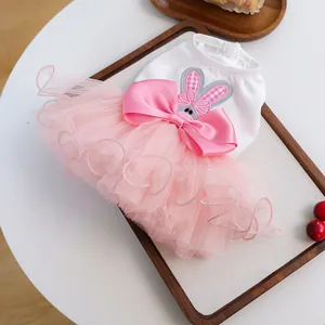 Detail view of pet dress with pink tutu skirt, rabbit embroidery, and large satin bow