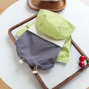 Detail of color-block pet jacket featuring drawstring hood and breathable mesh lining